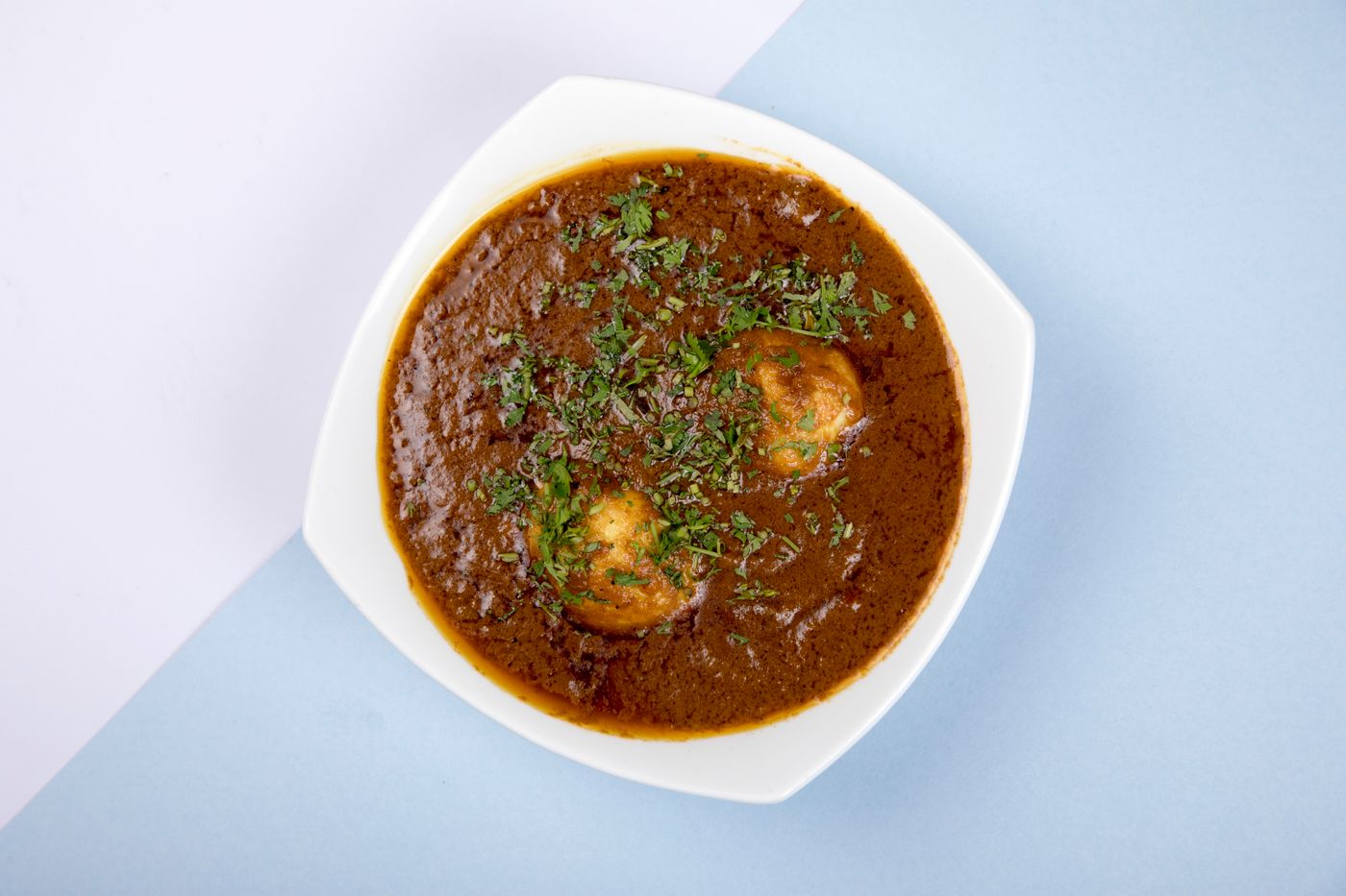 Egg and potato curry in a bowl