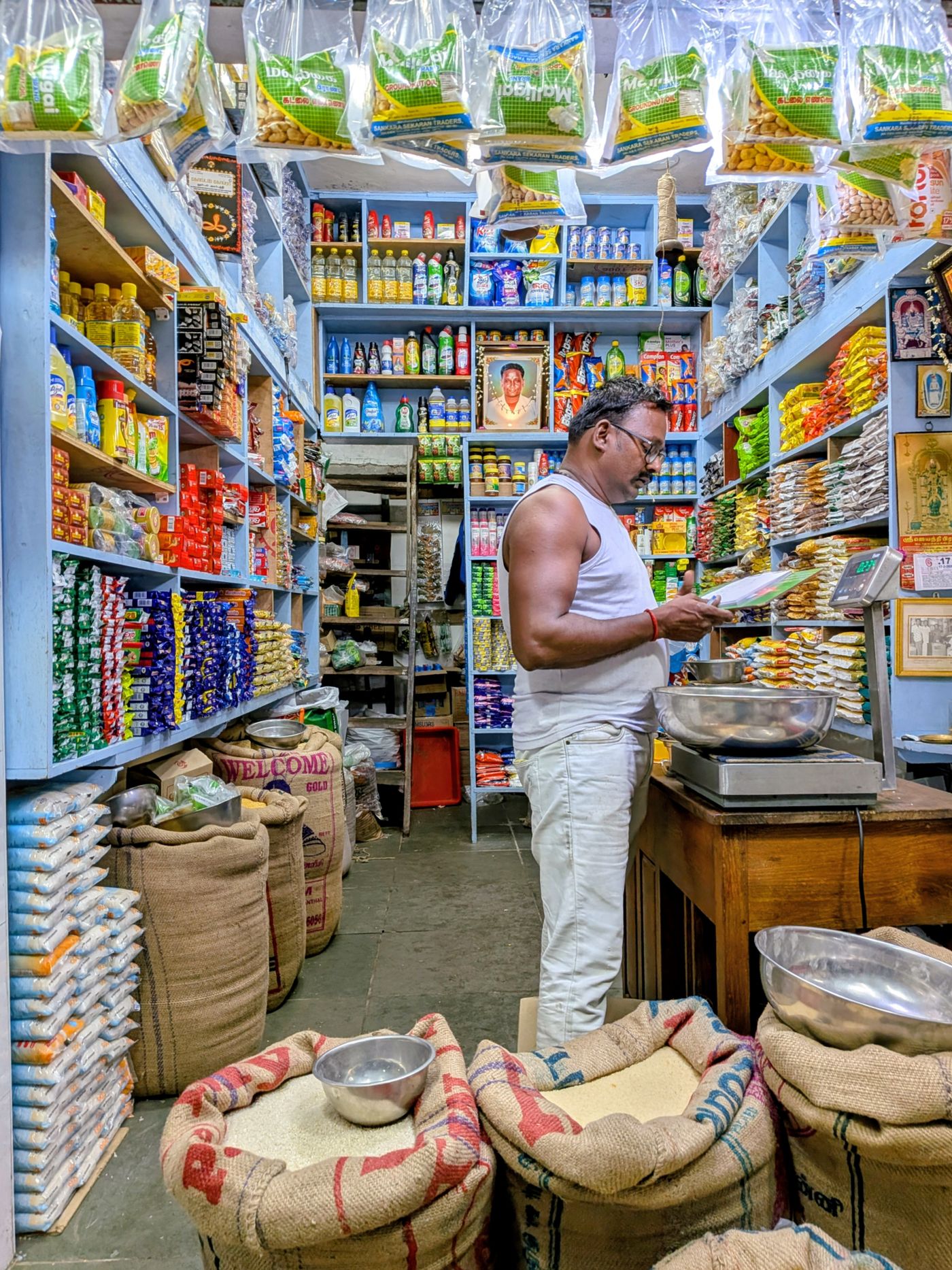 A shopkeeper in a busy grocery store
