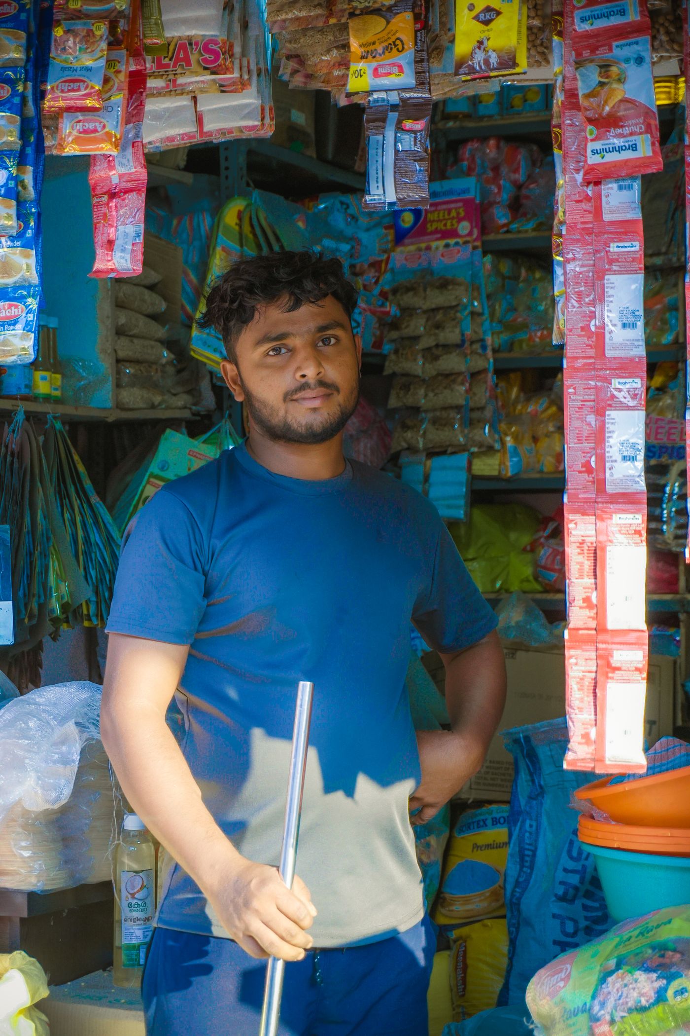 A shopkeeper standing in his grocery shop